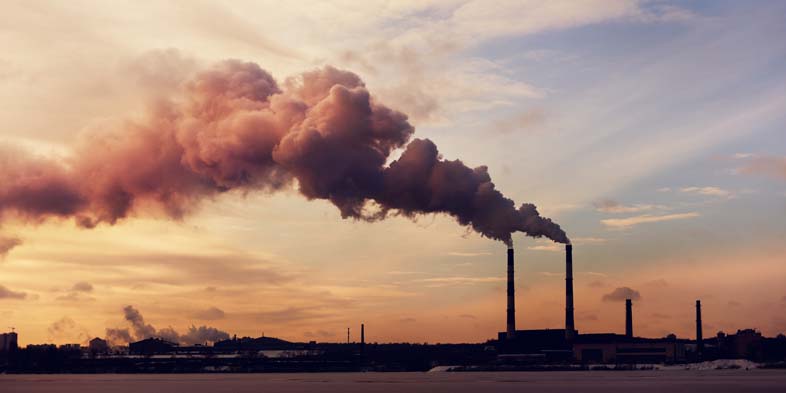 Factory with large amounts of smoke going into the air