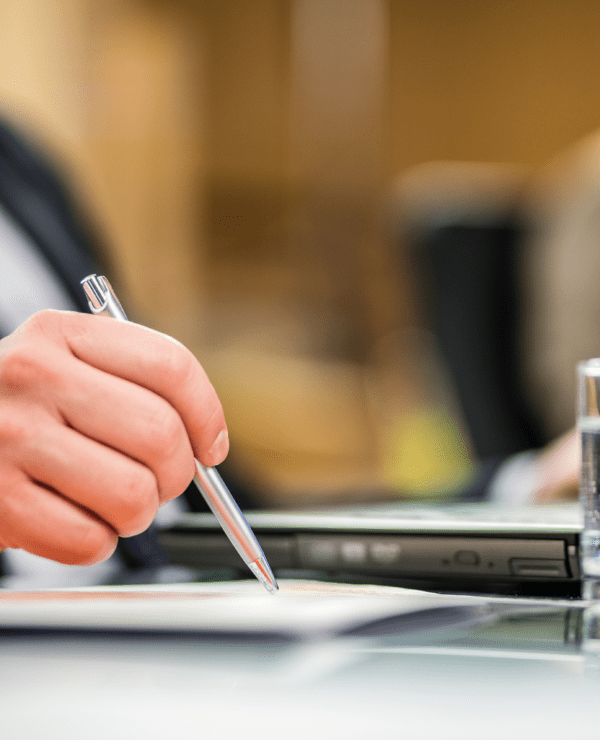 Business man holding a pen